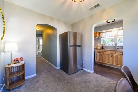 Dining room and hallway leading to restroom and bedrooms.