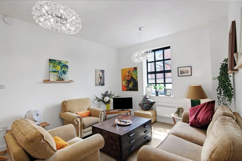 The living room showing the beautiful natural light from the windows and prints from the artist