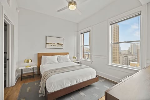 Unwind in crisp linens with bright city views.