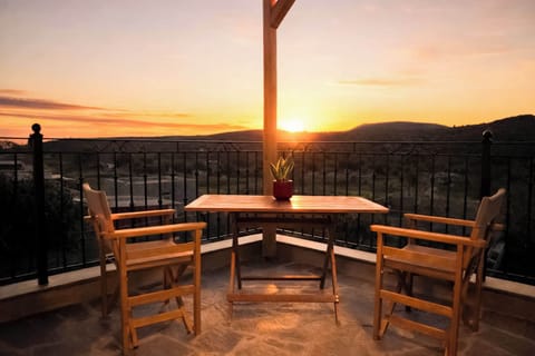 Outdoor Dining Area with Wooden Pergola and Sunset Views