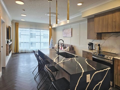 Stylish Calgary downtown condo kitchen with large island and dining area