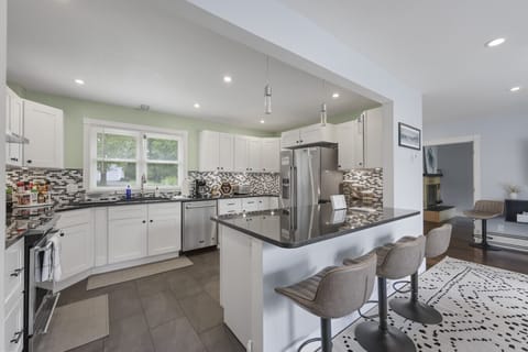 Fully equipped kitchen featuring stainless steel oven, stovetop, and dishwasher.