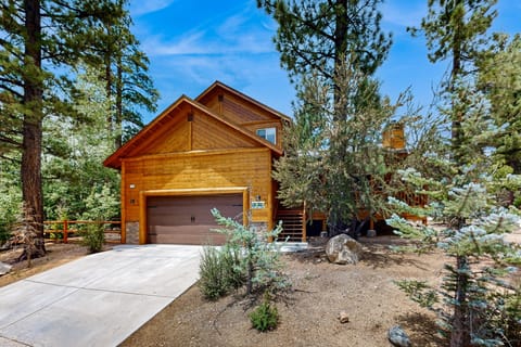 Welcoming cabin entry surrounded by towering pine trees, offering fresh mountain air and a peaceful forest setting—the perfect first impression for your Big Bear Lake getaway.