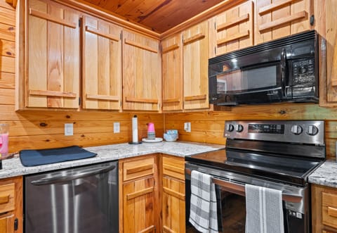 Fully stocked kitchen featuring stainless steel appliances, double sink, and plenty of cabinet space for meal prep.