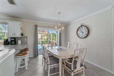 The dining table seats six with additional bar seating for three.