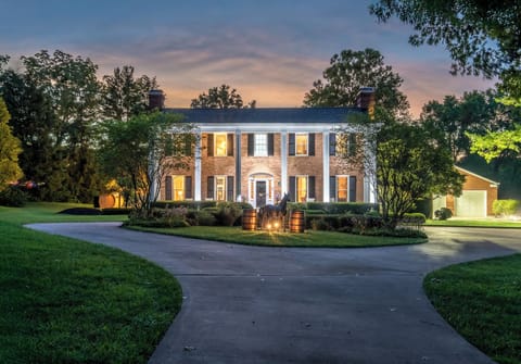 Proof of Life welcomes you w/ glowing twilight elegance by grand circular drive!