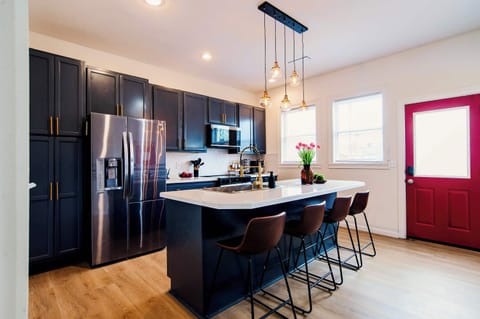 Sleek kitchen with stainless steel appliances, a spacious island, and everything you need for cooking or casual hangouts.