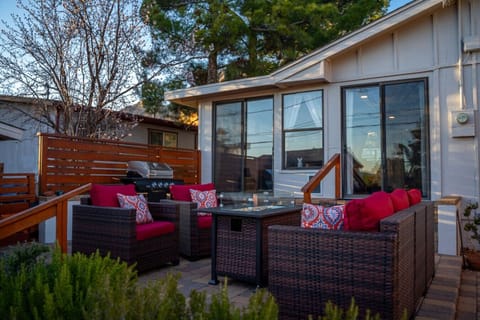Inviting patio with comfortable seating, vibrant cushions, and a cozy propane fire pit. Perfect for relaxing evenings, outdoor dining, or gathering under the stars.