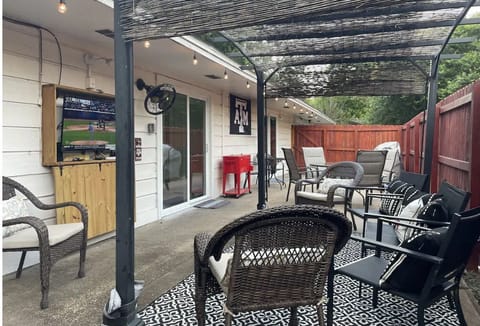 Large patio right outside the living area with TV,plenty of seating and 2 grills