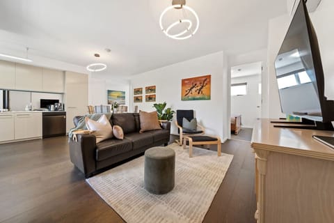 Bright and open living area with soft textures and natural light, perfect for relaxing after a day out.