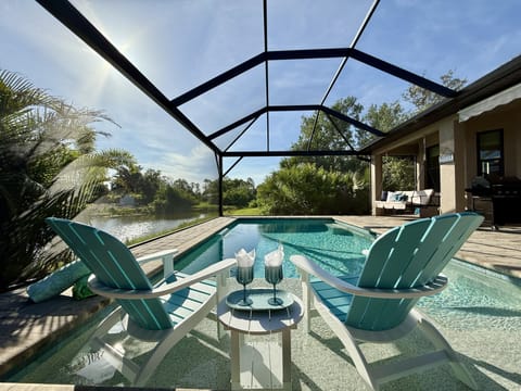 Enclosed pool with lake view, perfect for a sunny, relaxing afternoon.