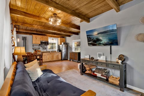 Bright living room with modern décor, cozy seating, and natural sunlight.