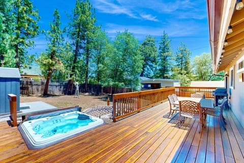Private outdoor hot tub, surrounded by tall pines, perfect for relaxing under the trees after a day of adventure—enjoy peaceful forest views, fresh air, and a truly rejuvenating stay.