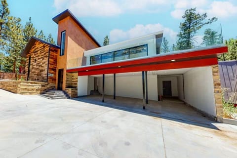 Welcoming cabin entry surrounded by towering pine trees, offering fresh mountain air and a peaceful forest setting—the perfect first impression for your Big Bear Lake getaway.