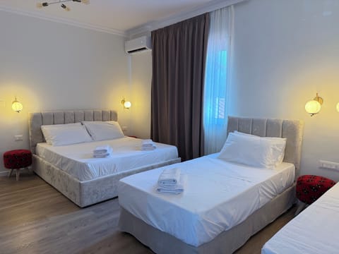 Standard Quadruple Room, City View | Desk, laptop workspace, blackout drapes, iron/ironing board