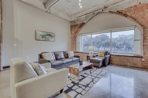 Modern elegance meets urban charm with stylish furniture and vibrant art. Perfect for gatherings!