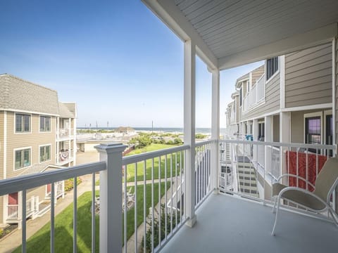 Private balcony with peekaboo ocean views and cozy seating.