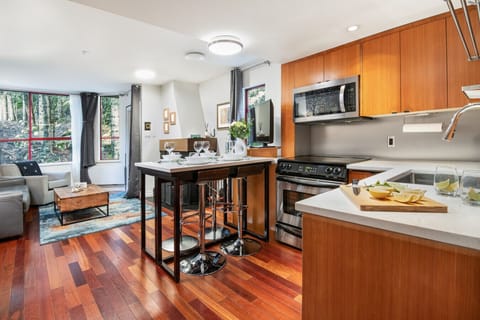 Open-plan living area with kitchen and dining for four.