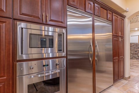 Kitchen is completely stocked with high end appliances that include dual fridges and a mini wine fridge.