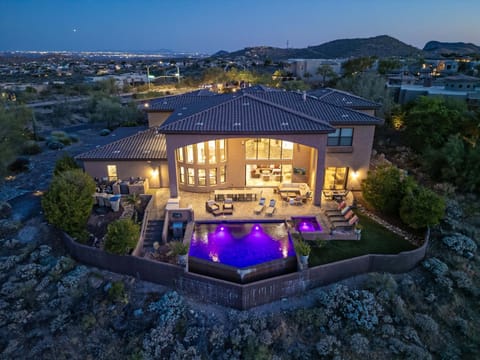 Home is situated in the heart of the Sonoran Desert with brilliant city lights in the distance.