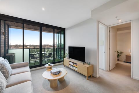 Natural Light through the balcony to the living room with sofa bed and smart TV