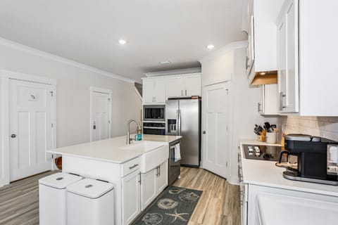 Fully equipped kitchen with stainless appliances and quartz counters
