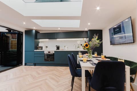 Gather, dine, and make memories in this exquisite open-plan kitchen and dining space. Flooded with natural light from the skylights, it’s perfect for preparing culinary delights or enjoying a sumptuous meal.