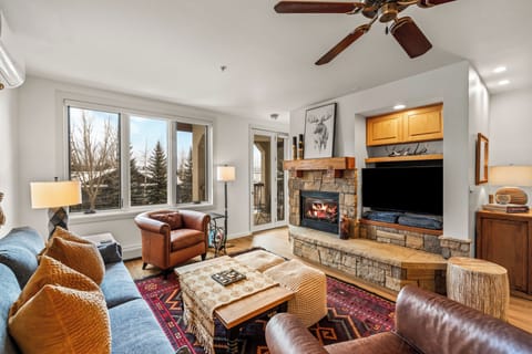 Cozy up in your mountain living room with crackling fireplace and stunning views through floor-to-ceiling windows.