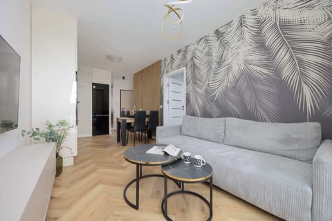Relax in the stylish living room with a comfortable sofa and modern decor.