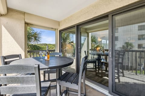 Balcony with 4-person table and chairs