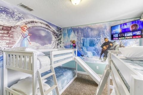 Create unforgettable family memories in this playful Frozen bedroom with a slide, bunk beds, and vibrant Disney décor