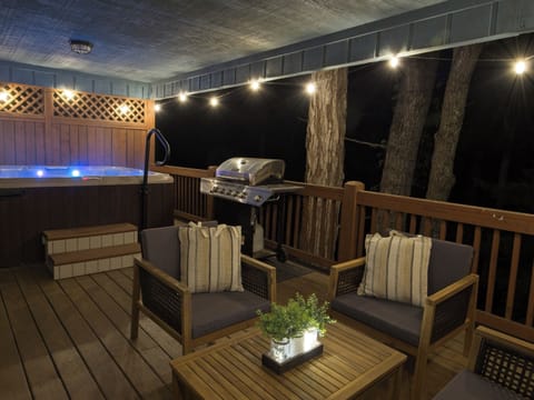 Step onto the deck after dark — the hot tub glows under string lights while the Blue Ridge night closes in around you. Everything you need is right here.