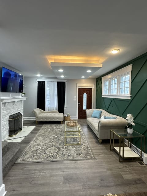 Elegantly designed living room featuring a cozy fireplace, smart TV, and seating