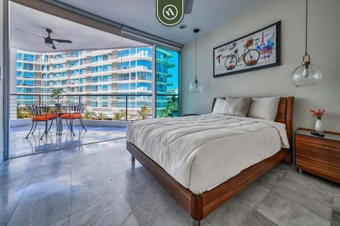 Wake up to stunning views! This spacious bedroom features a comfortable king bed and direct access to a private, sun-drenched terrace overlooking the resort.