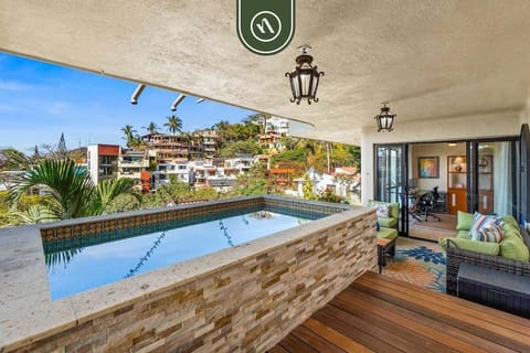 A covered private terrace featuring an infinity-edge plunge pool and a comfortable outdoor lounge area.