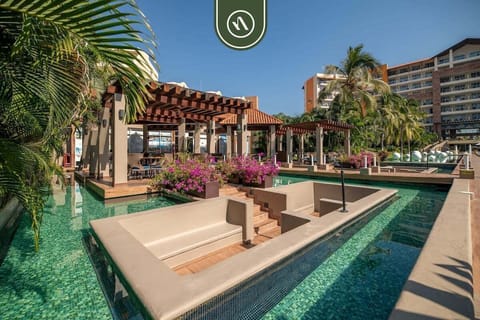 Escape to the resort's stunning pool area surrounded by lush landscaping, sun decks, and relaxing lounge spaces.