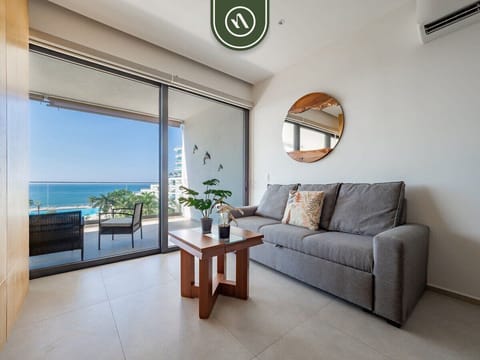 A chic living space that opens directly onto a private terrace through floor-to-ceiling glass doors. Enjoy breathtaking ocean views right from the comfort of the sofa.