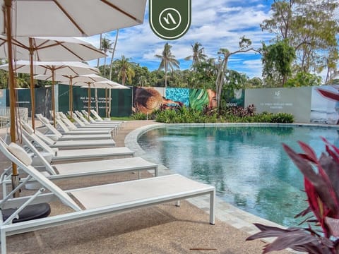 Relax by the stunning resort-style pool surrounded by tropical landscaping, comfortable loungers, and a peaceful atmosphere.