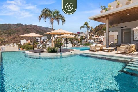 Enjoy the rooftop infinity pool with panoramic coastline views. Relax poolside, soak up the sun, or take an evening swim in this resort-style oasis.