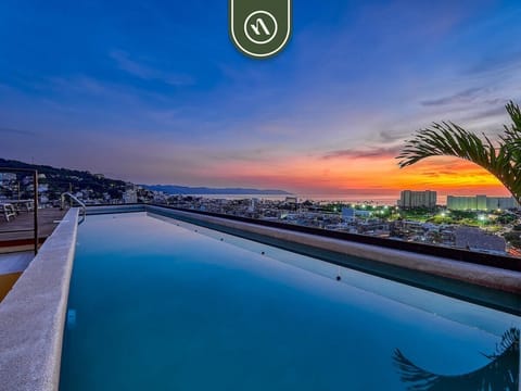 Take in a breathtaking sunset over the ocean bay from the edge of a crystal-clear rooftop infinity pool overlooking the city.