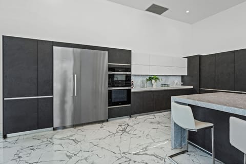 Modern kitchen features stainless steel appliances.