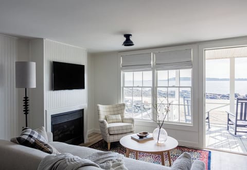 Unwind on the sofa with bright windows and ocean views.