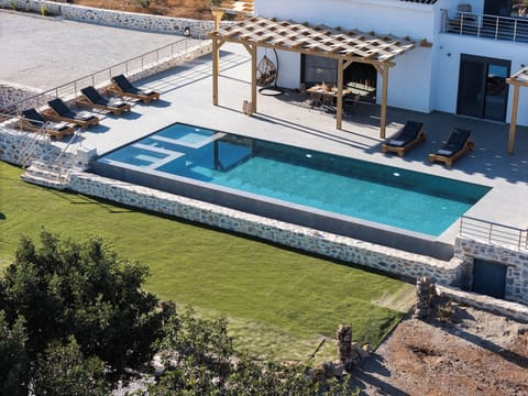 Dive into serenity in your 50m² heated pool with sea-kissed views.