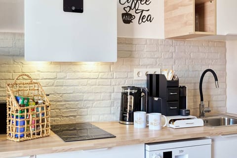 Kitchen with two ceramic hubs, extractor, and a coffee station with a kettle, a Nespresso machine, and Nespresso capsules for you to enjoy during your stay.
