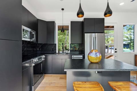 Fully equipped kitchen with sleek cabinetry & stainless appliances.