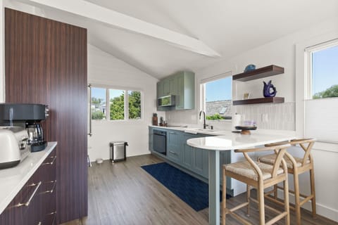 The modern kitchen is equipped with full-size appliances and a breakfast bar