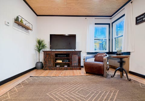 Sunlit living area featuring hardwood floors and mid-century design.