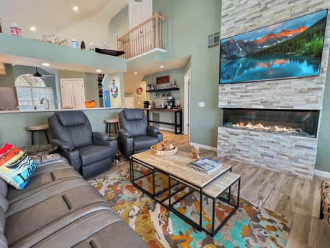 Beautiful living room with fireplace as the center attraction. You will relax for hours in the electric recliners and the two electric massage recliners.  This is not your typical vacation rental, this is a vacation experience