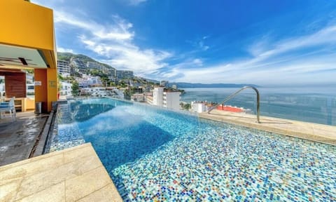 Relax and cool off in our beautiful panoramic pool. Enjoy breathtaking views of the bay and the horizon right from the water. It's the perfect spot to soak up the sun, read a book, or simply take in the stunning scenery.