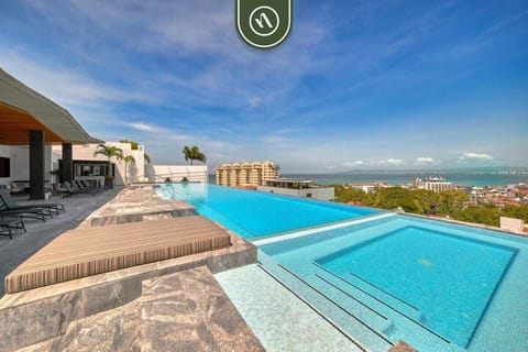 Spectacular rooftop infinity pool and hot tub overlooking the ocean and city.